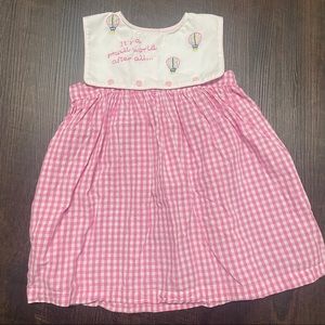 Boutique Brand “It’s a Small World” button on bib dress